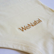WeNatal x Tabeeze Bottom Up Bodysuit featuring patented Shoulder Snaps, designed for easy diaper changes and skin-to-skin bonding, made from organic jersey cotton.